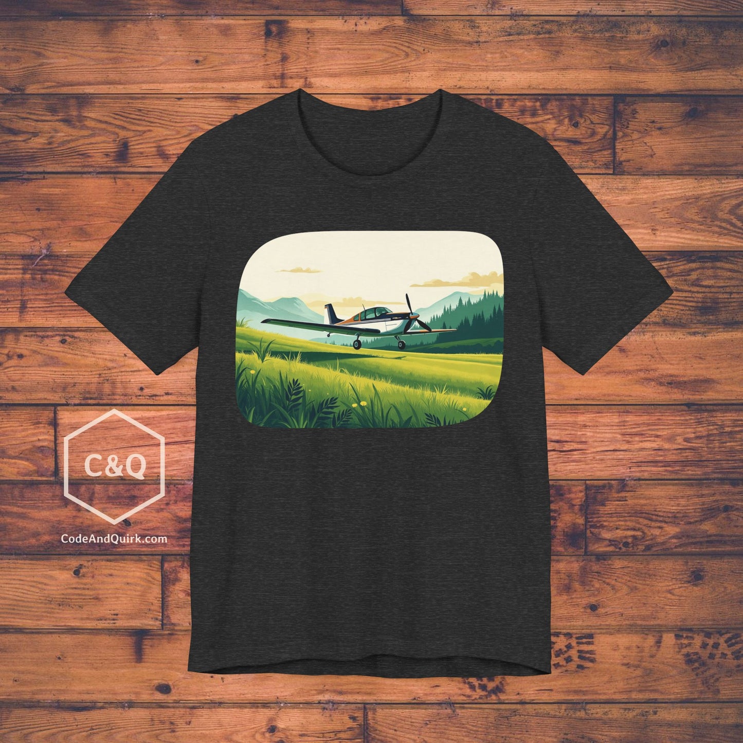 Small plane landing on grass amidst mountains - aviation fan's T-Shirt