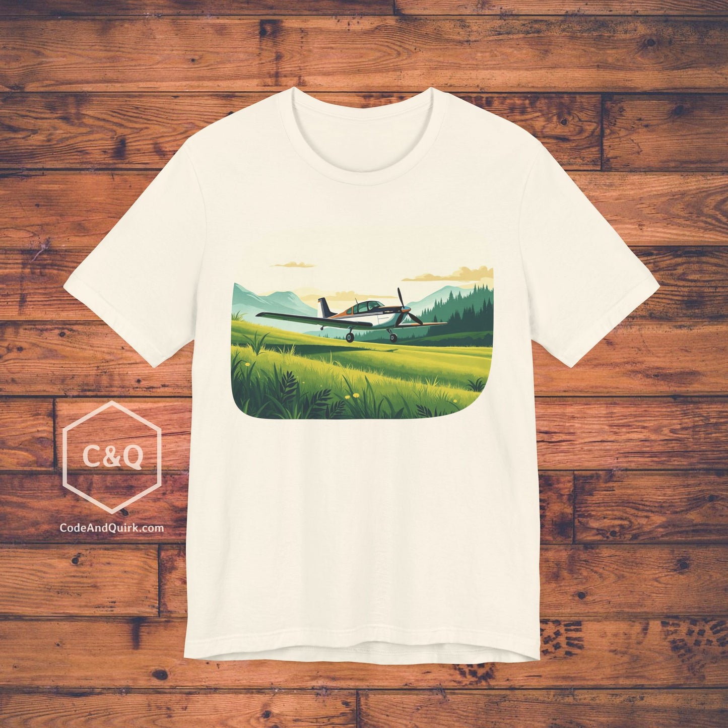 Small plane landing on grass amidst mountains - aviation fan's T-Shirt