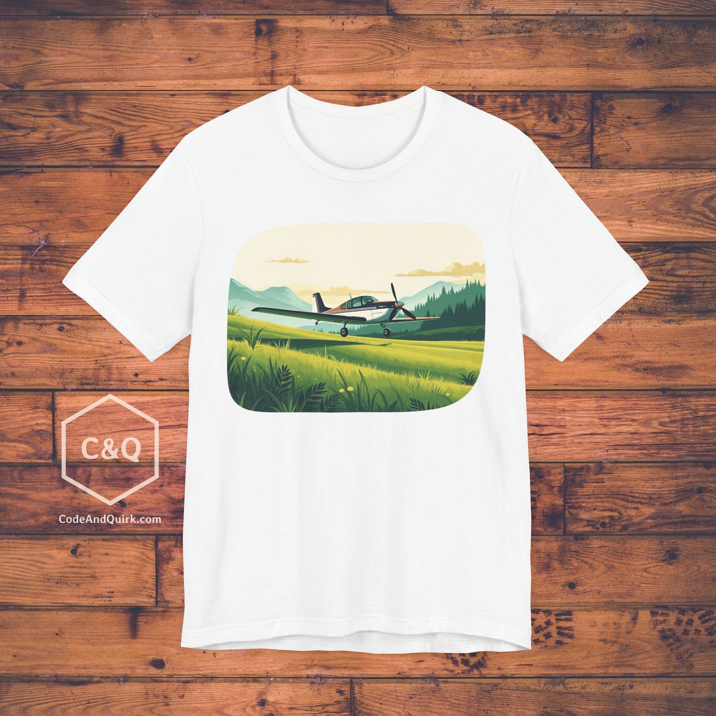 Small plane landing on grass amidst mountains - aviation fan's T-Shirt