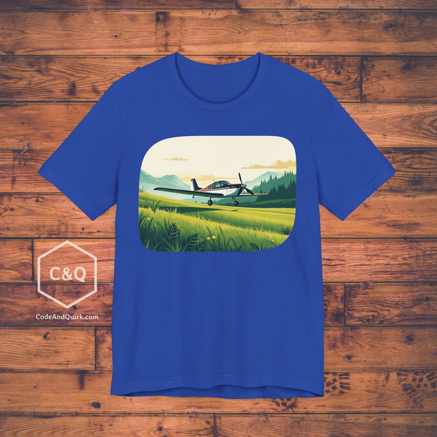 Small plane landing on grass amidst mountains - aviation fan's T-Shirt