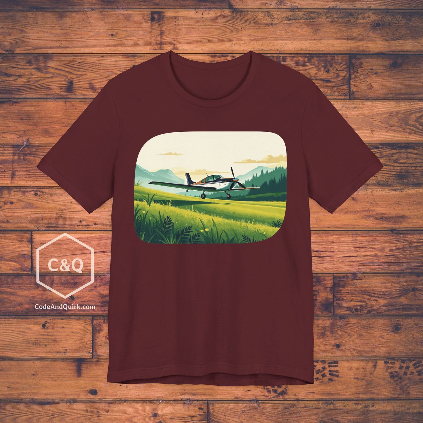 Small plane landing on grass amidst mountains - aviation fan's T-Shirt