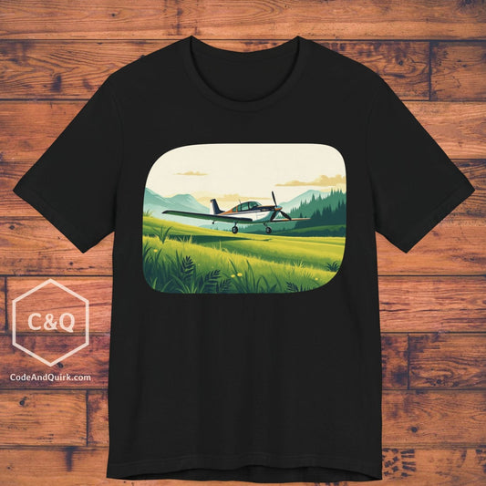 Small plane landing on grass amidst mountains - aviation fan's T-Shirt