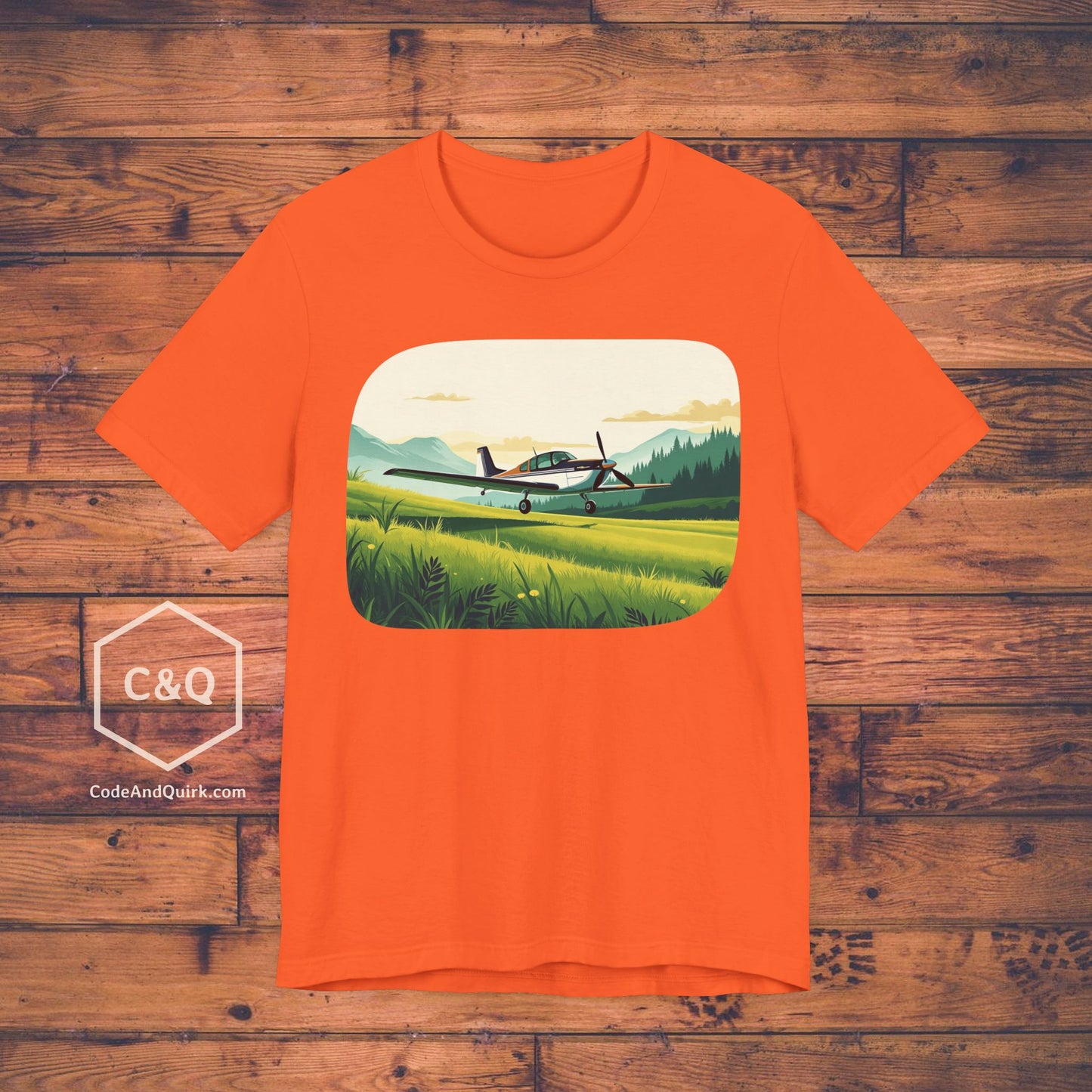 Small plane landing on grass amidst mountains - aviation fan's T-Shirt