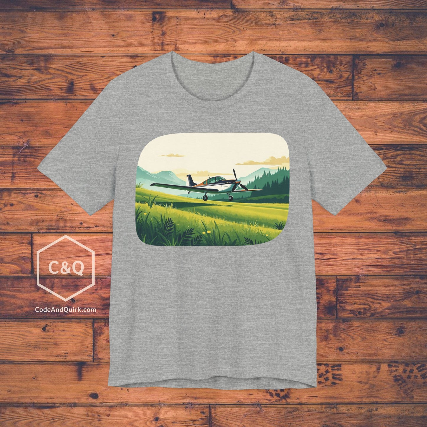 Small plane landing on grass amidst mountains - aviation fan's T-Shirt